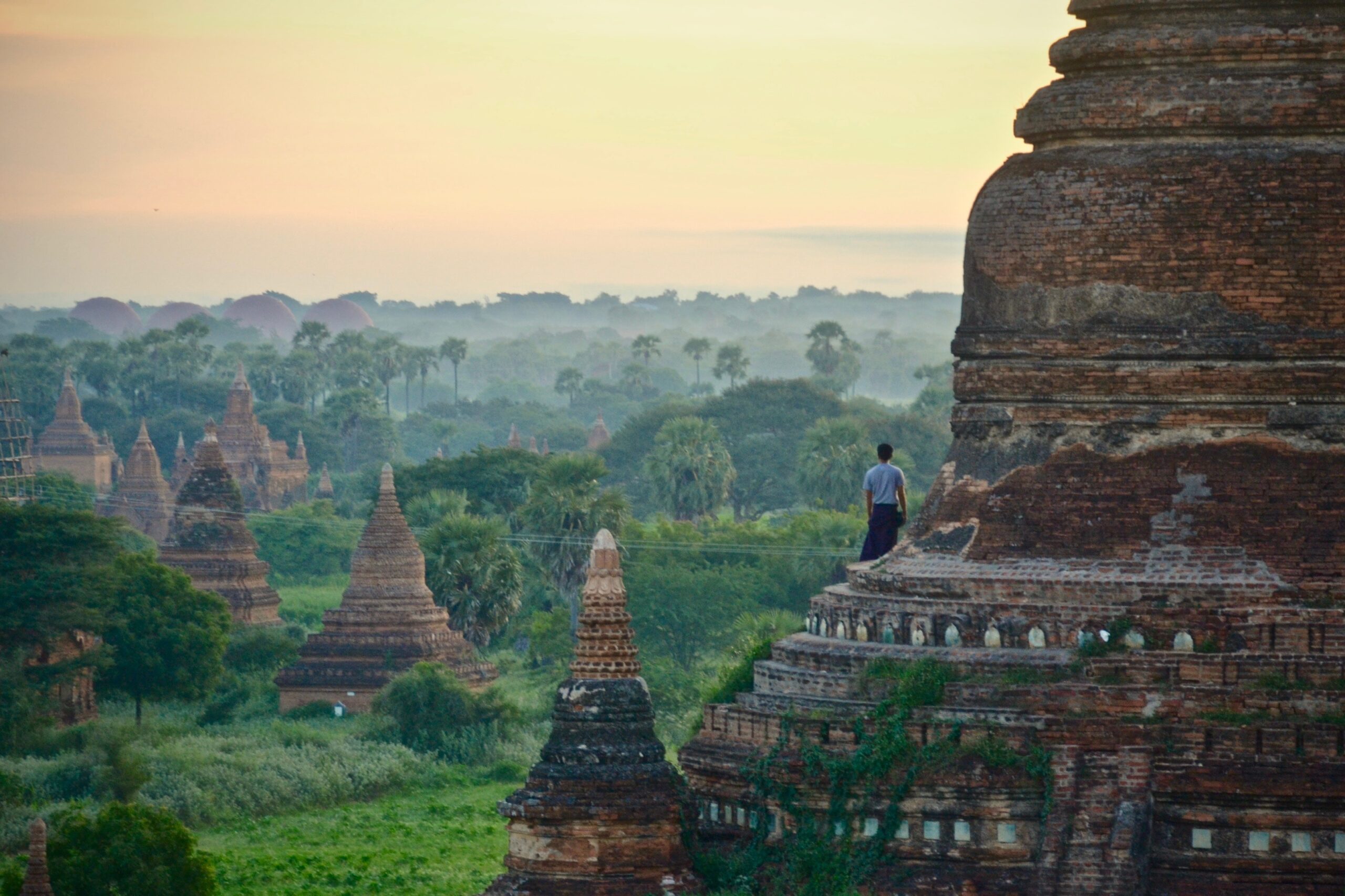 Man stands on one of the temples of Bagan, a testament to Burmese culture