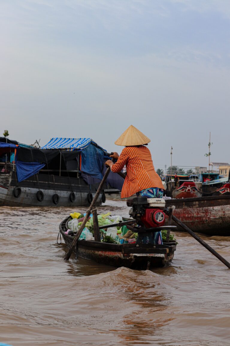 Vietnamese woman paddling on the river