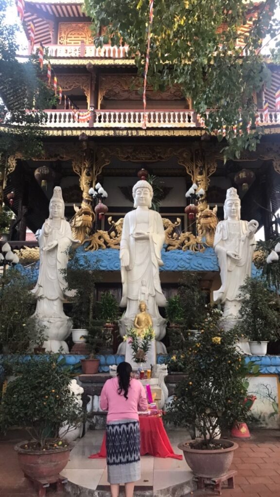 A woman standing in one of the hidden temples in Vientiane